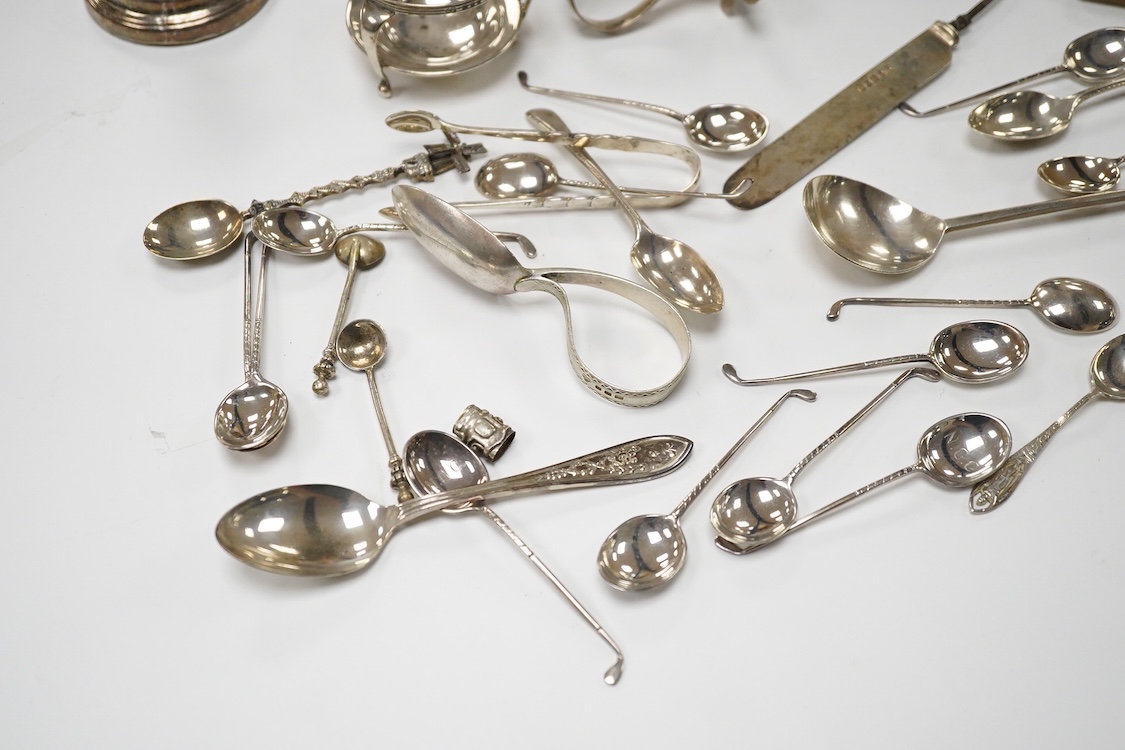 A small quantity of assorted small silver and plated flatware, a small silver stand, a silver napkin ring and a pair of modern silver mounted dwarf candlesticks.